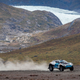 An Extreme E off-roader races across a glacier.